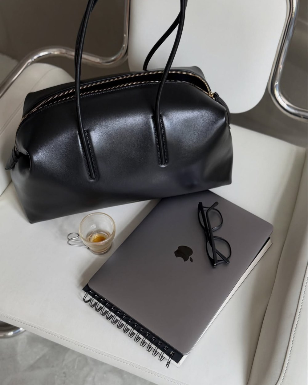 Leather bag and laptop on a desk